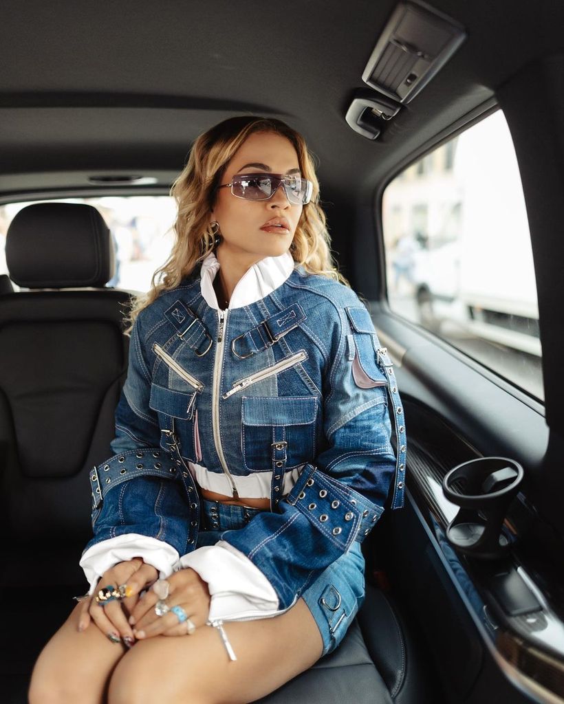 Rita Ora in a car wearing sunglasses