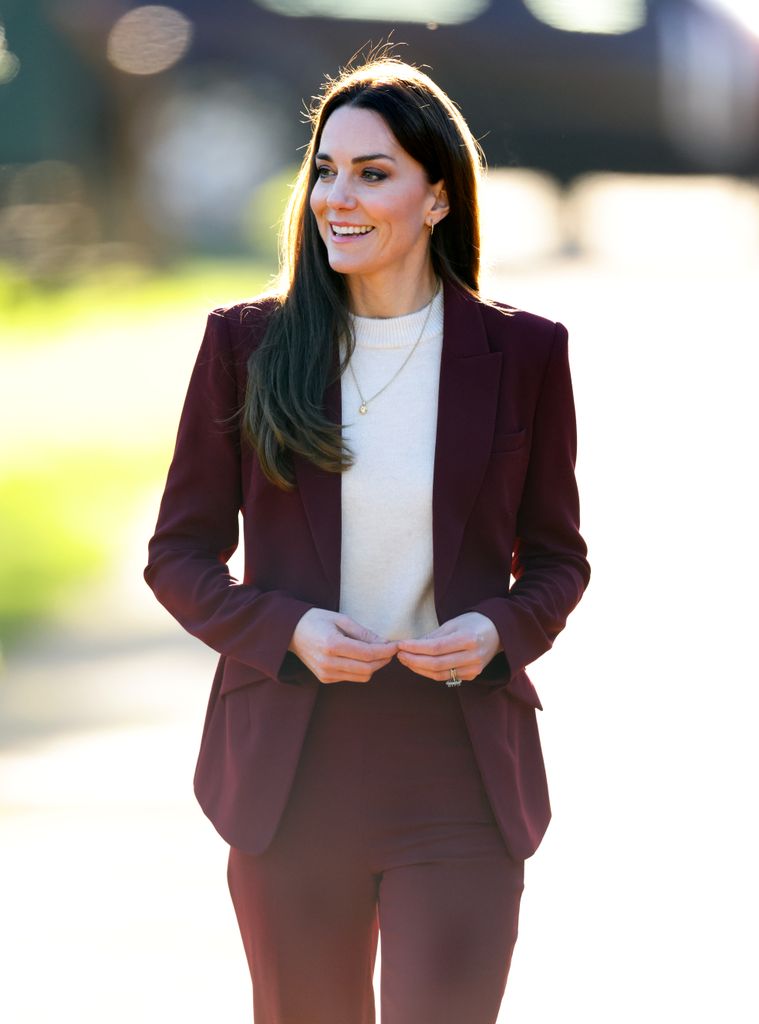 Kate Middleton wearing burgundy trouser suit