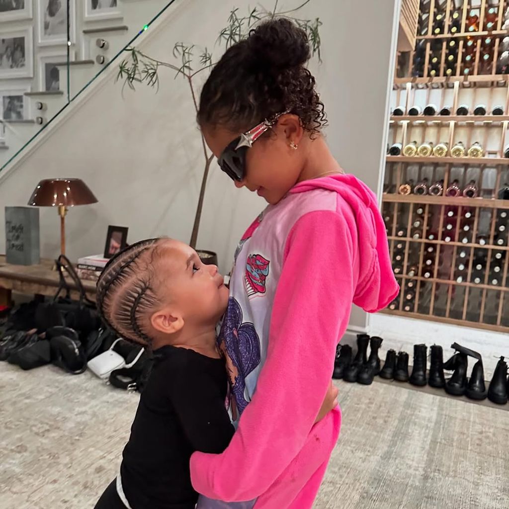 Stormi and Aire standing in hallway of their home