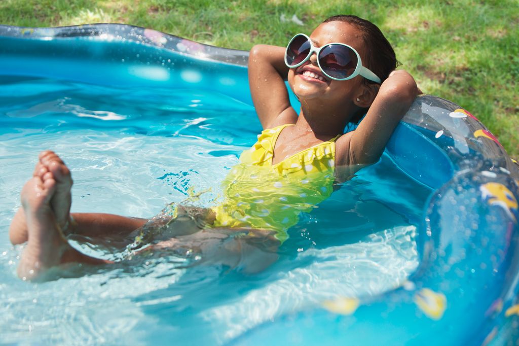 girl relaxing in kiddie pool