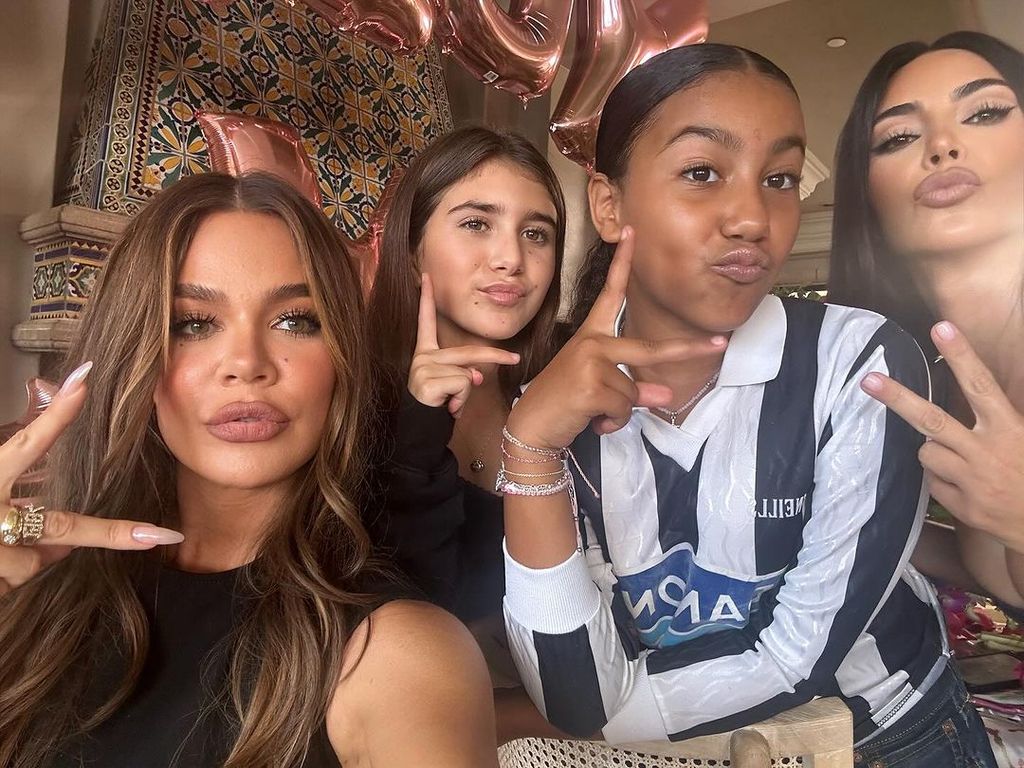 Khloe poses with her nieces and sister Kim, North's mom