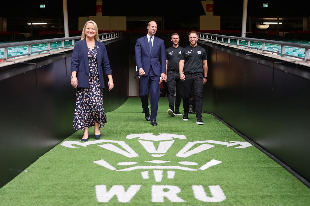 Prince William walking into stadium with Elizabeth Thomas-Evans, the CEO of the Jac Lewis Foundation
