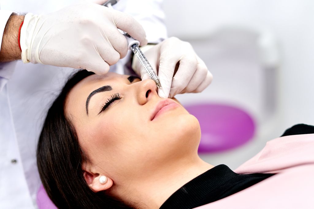 Woman receiving hyaluronic acid injection in medical practice