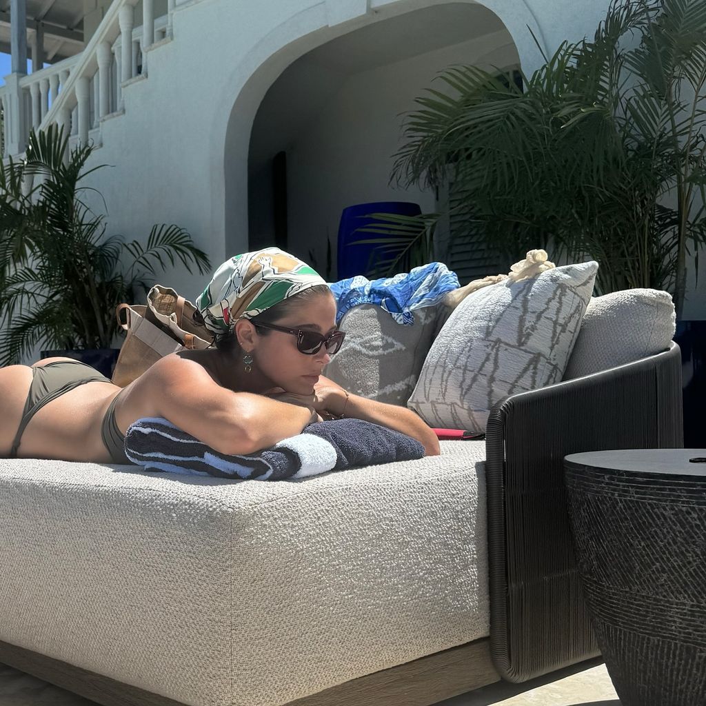 Lola Consuelos sunbathes in a green bikini