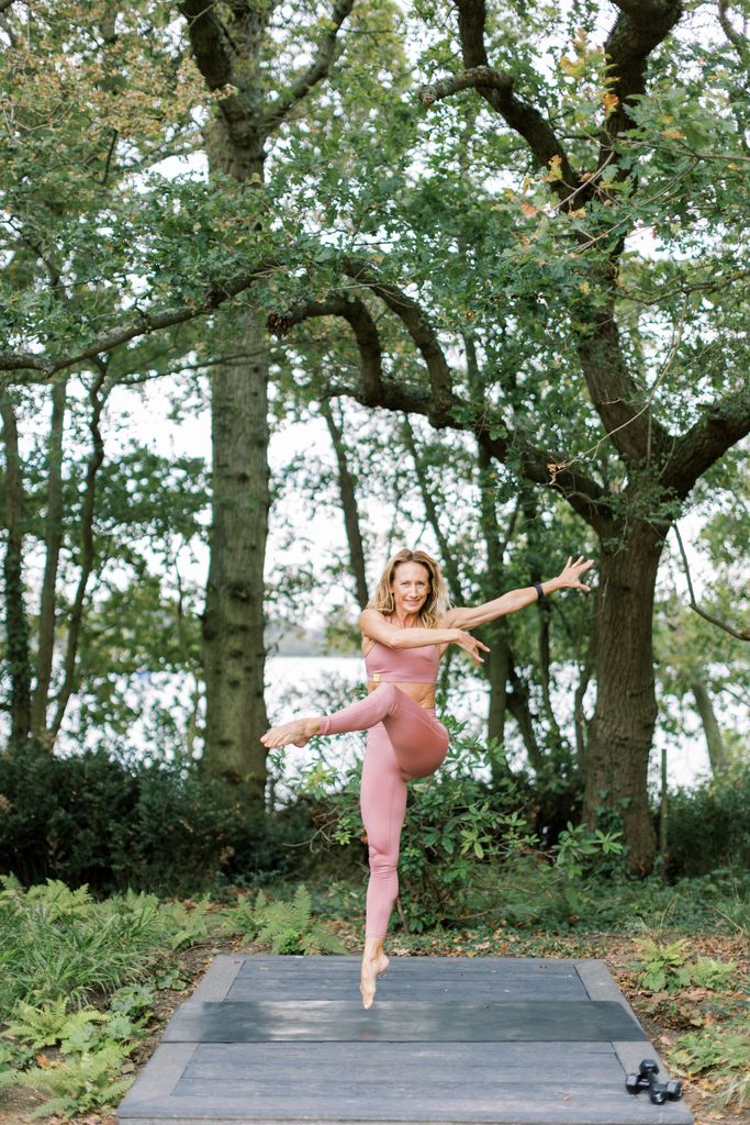 Lady jumping in pink active wear