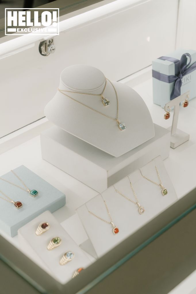 Many gold necklaces on display in a shop