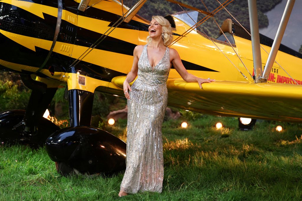 woman laughing holding onto plane