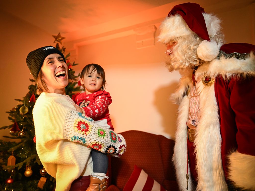 mother holding daughter in santa's grotto 