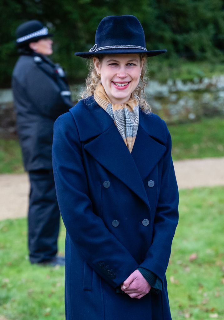 Lady Louise Windsor smiling in hat and coat