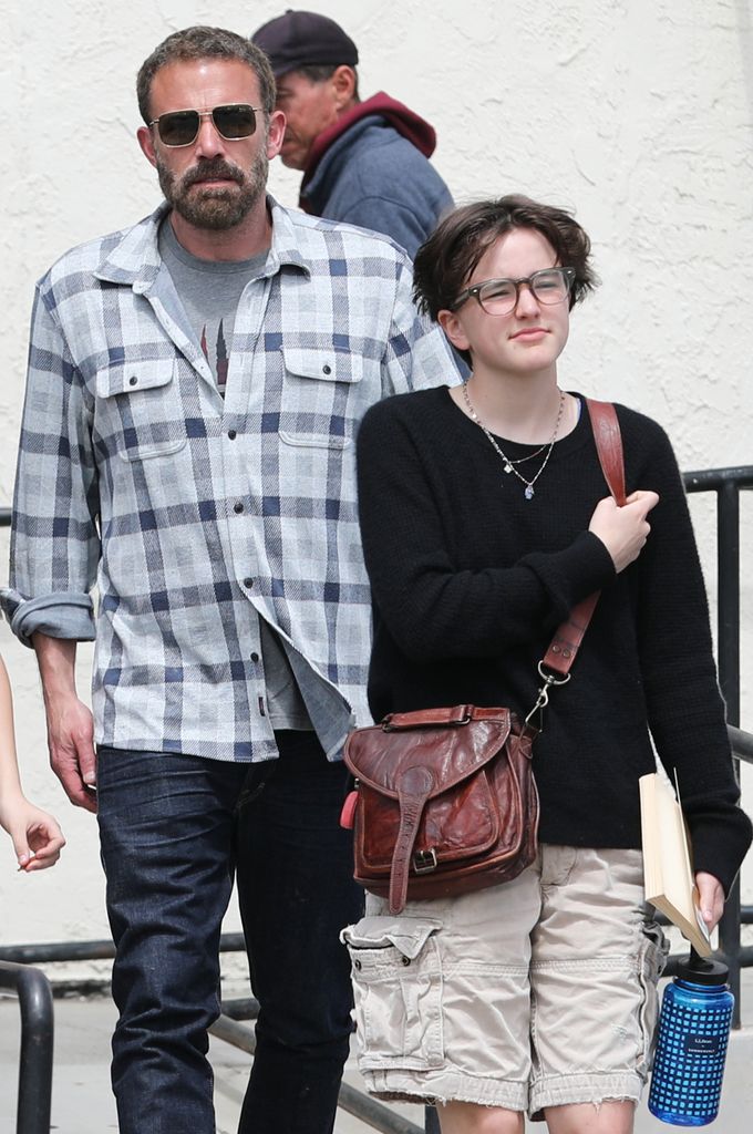 Fin looks happy glasses soft hair dad Ben Affleck walks behind