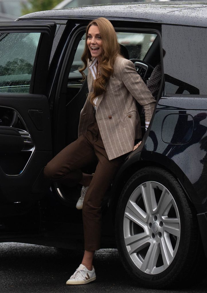 The Princess of Wales getting out of car in blazer and trousers