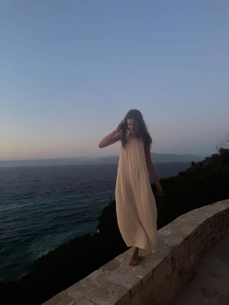 Sunday posed in front of the ocean