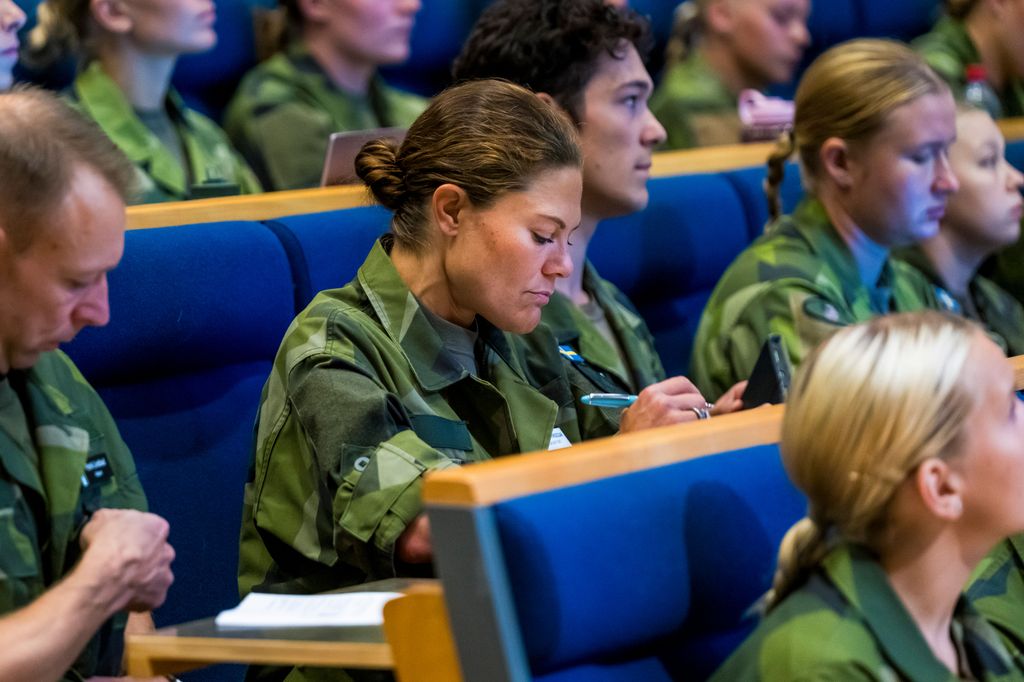 Crown Princess Victoria writing at desk during military training