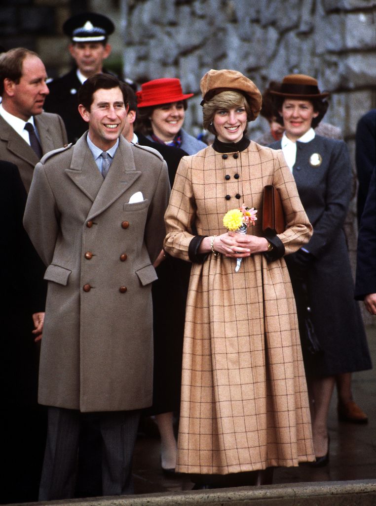 The Prince and Princess of Wales visit Barmouth in Wales, November 1982. She wears a suede beret by John Boyd and a coatdress by Arabella Pollen.