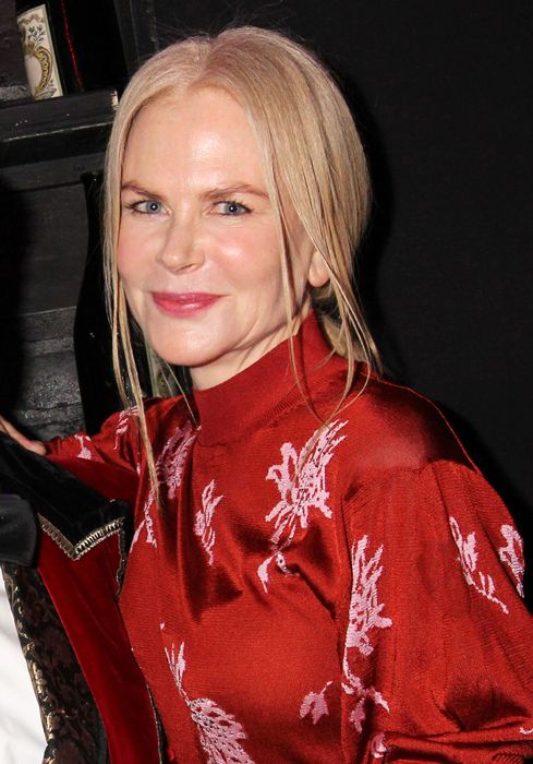 Nicole Kidman in red smiling at the camera