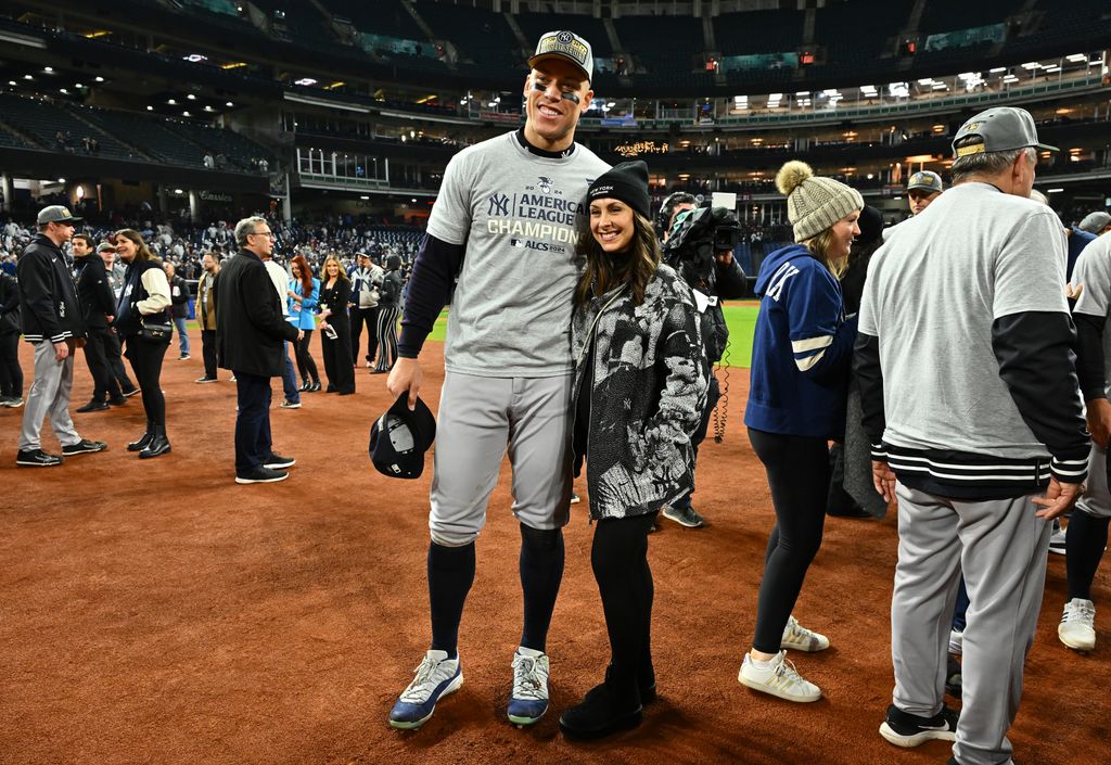 Aaron Judge #99 of the New York Yankees and wife Samantha Bracksieck pose for photos after the New York Yankees beat the Cleveland Guardians 5-2 in 10 innings in Game Five of the American League Championship Series 