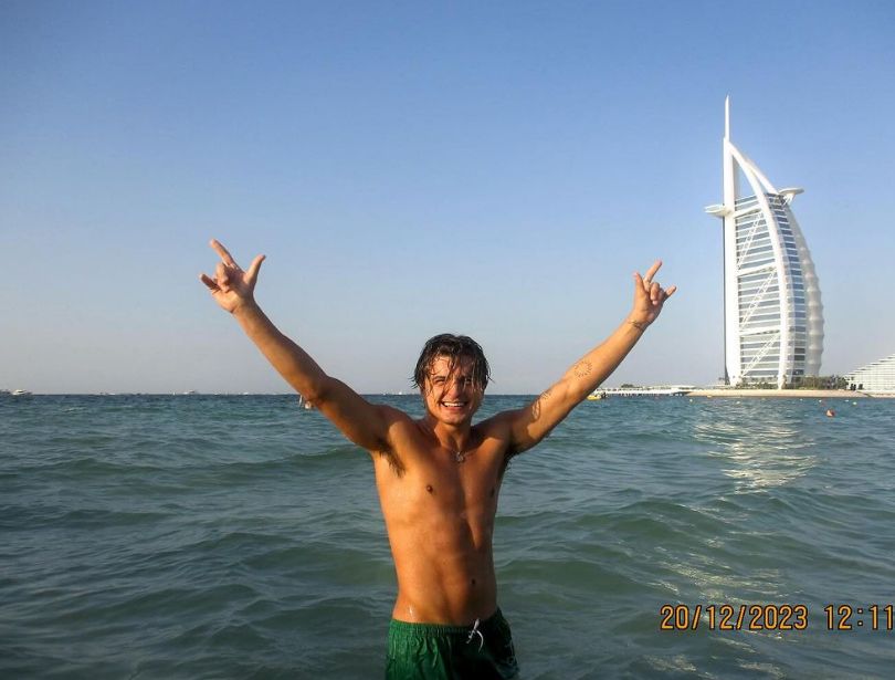 Nikita Kuzmin in green swim shorts in the sea