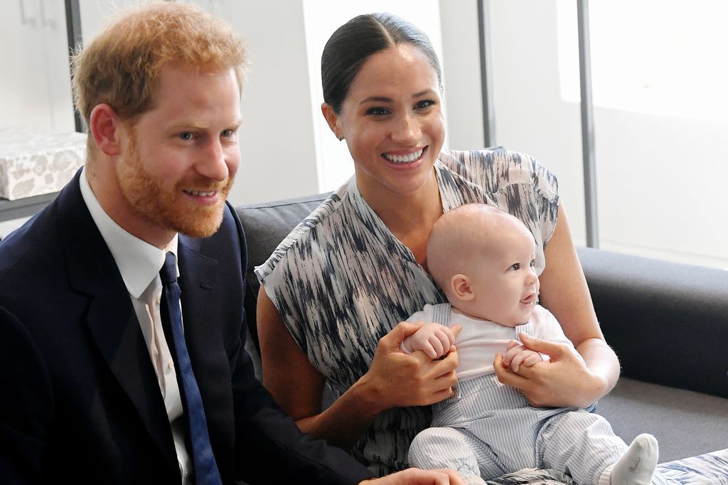 Harry and Meghan smiling with baby Archie in South Africa