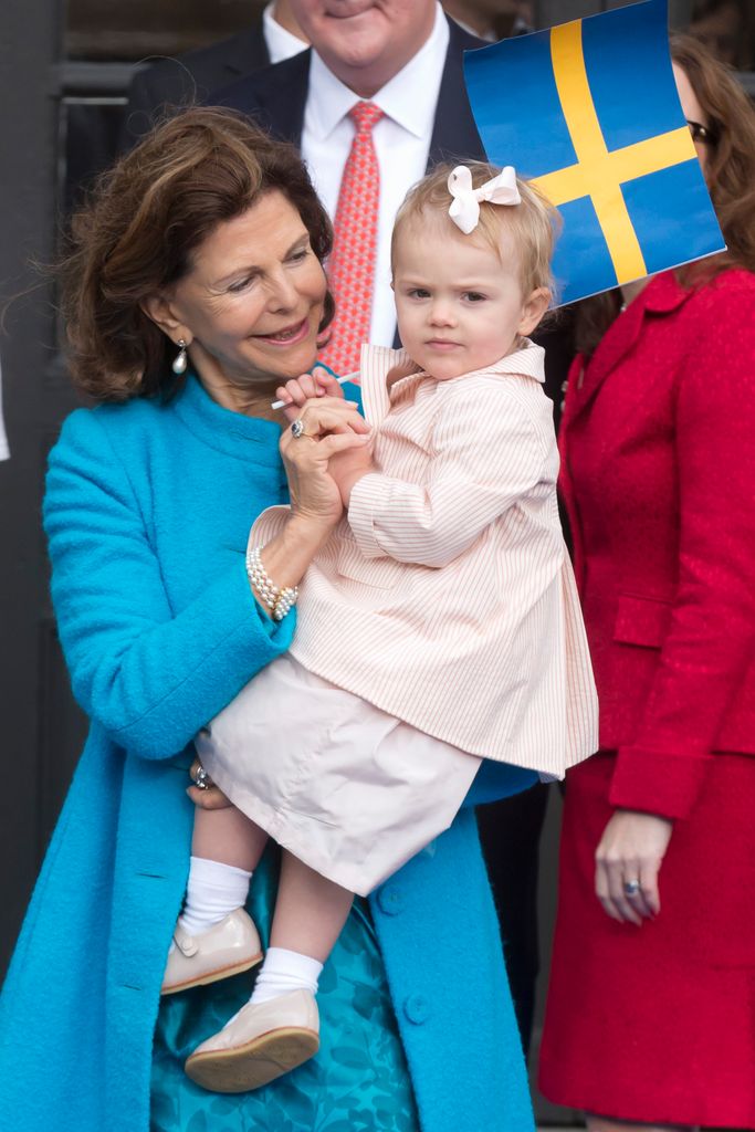 Queen Silvia holds Princess Estelle