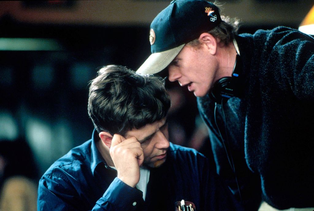 Director Ron Howard speaks with actor Russell Crowe on the set of the film "A Beautiful Mind."