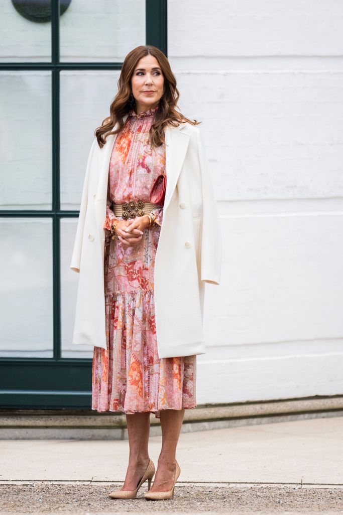 Queen Mary in pink floral dress with white coat