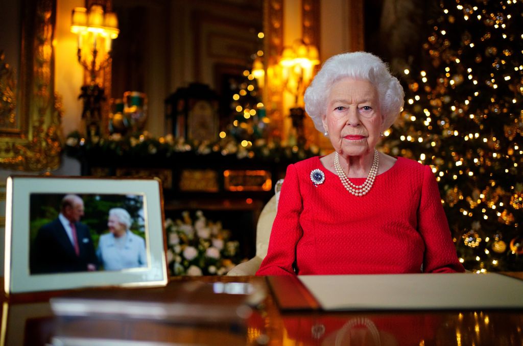 Queen Elizabeth II in red dress in front of Christmas tree