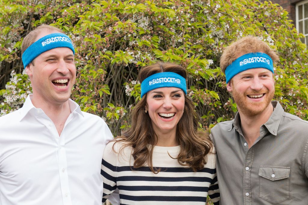 William, Kate and Harry wearing blue heads together headbands 