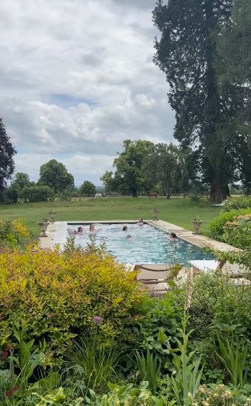 outdoor pool with people in it 