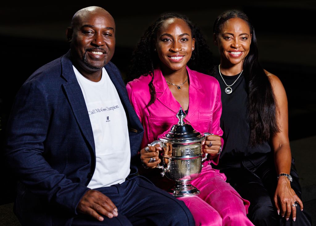 Coco Gauff poses with her parents Corey and Candi Gauff with the winner's trophy after beating Aryna Sabalenka of Russia in the final of the women's singles at the US Open on September 09, 2023 in New York City