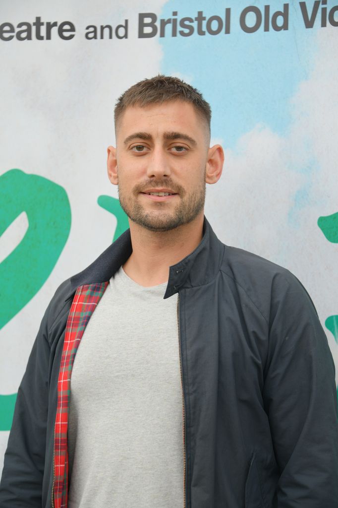Michael Socha in a coat and grey shirt