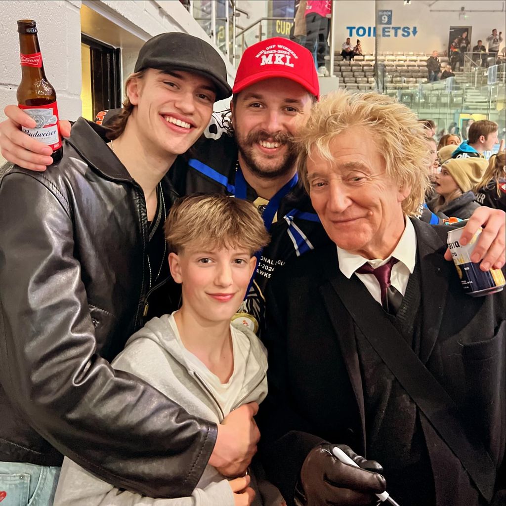 Rod on ice rink with sons