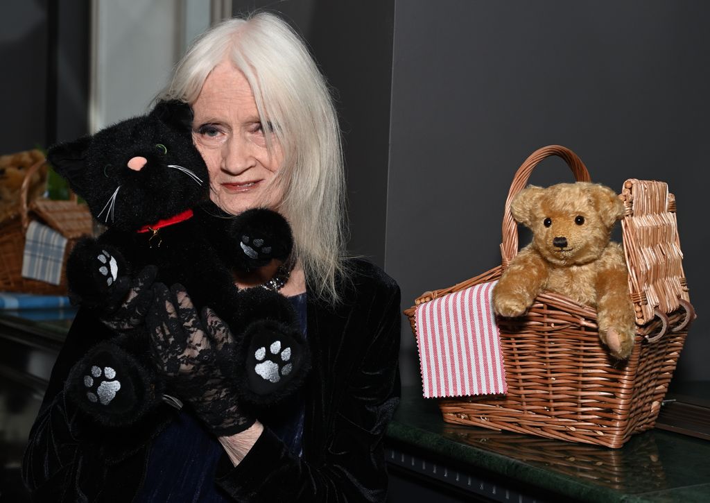 Celia Hammond wears black because she holds a cat teddy bear