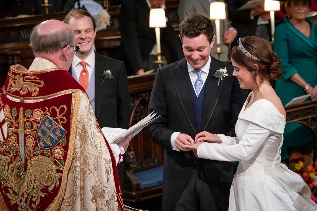Jack Brooksbank placing a wedding band on the finger of Princess Eugenie