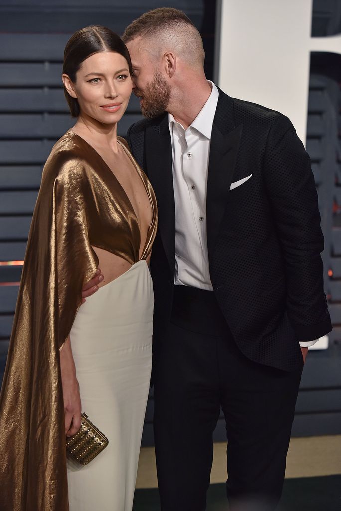 Justin Timberlake whispering to Jessica Biel on the red carpet
