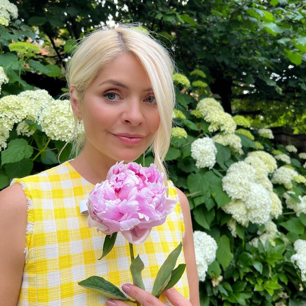 Holly holding a peony flower 