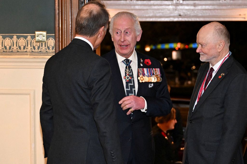 Britain's King Charles III (C) arrives to attend "The Royal British Legion Festival of Remembrance" ceremony at Royal Albert Hall