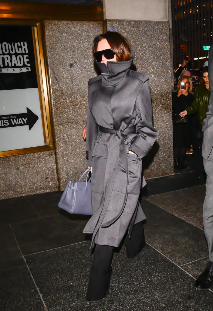 Victoria Beckham in an on-trend funnel neck coat from her own collection
