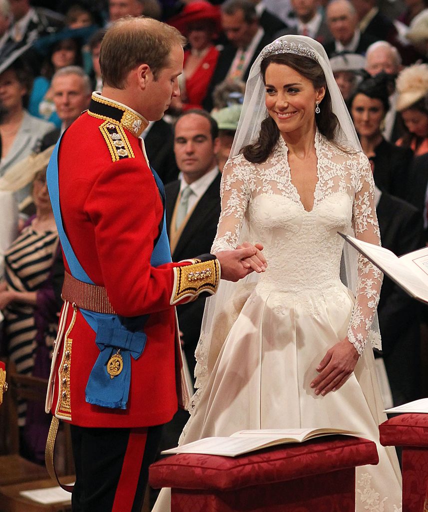 Prince William holds the hand of his bride Catherine