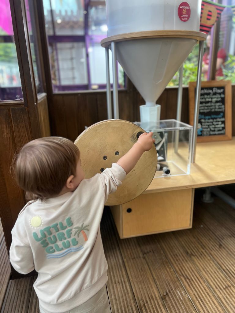 young boy turning a wheel 