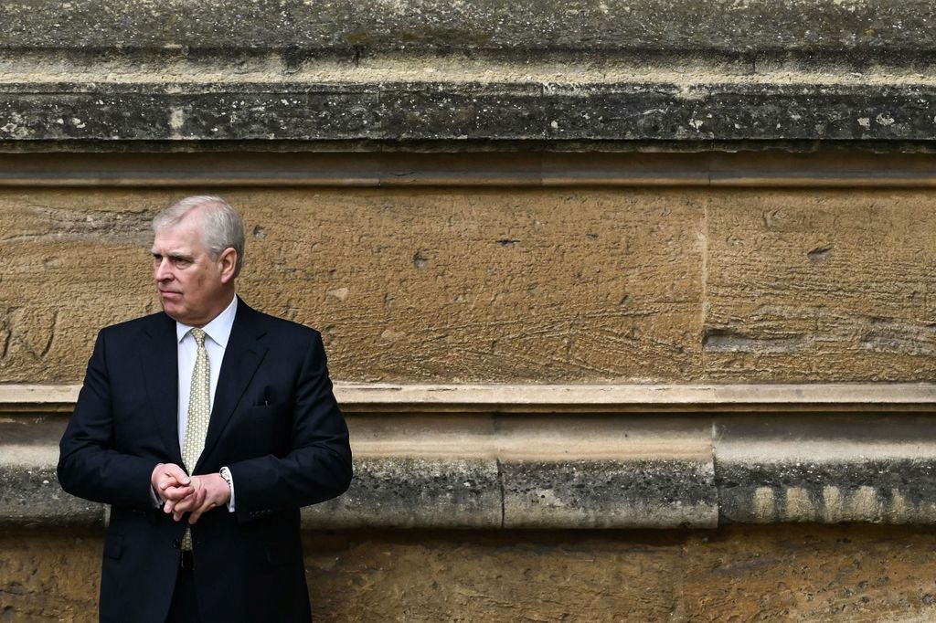 Prince Andrew standing by a wall