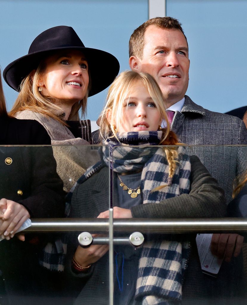 Harriet Sperling, Isla Phillips and Peter Phillips watch the racing as they attend the New Year's Day Racing Meet at Cheltenham Racecourse