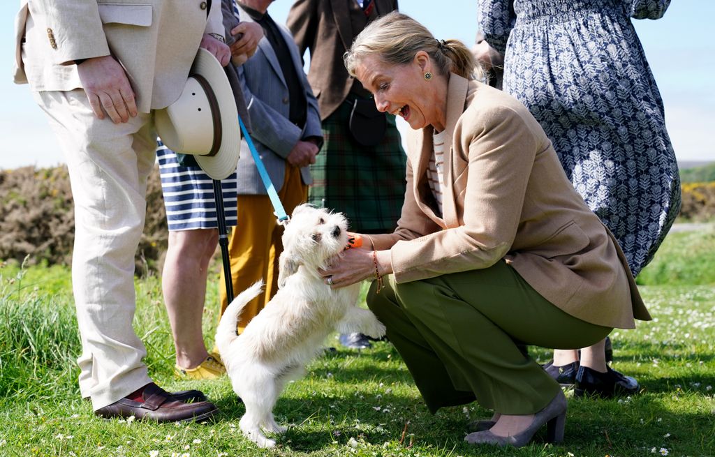 The Duchess of Edinburgh meets Loki the dog during a visit to Golspie, Sutherland.