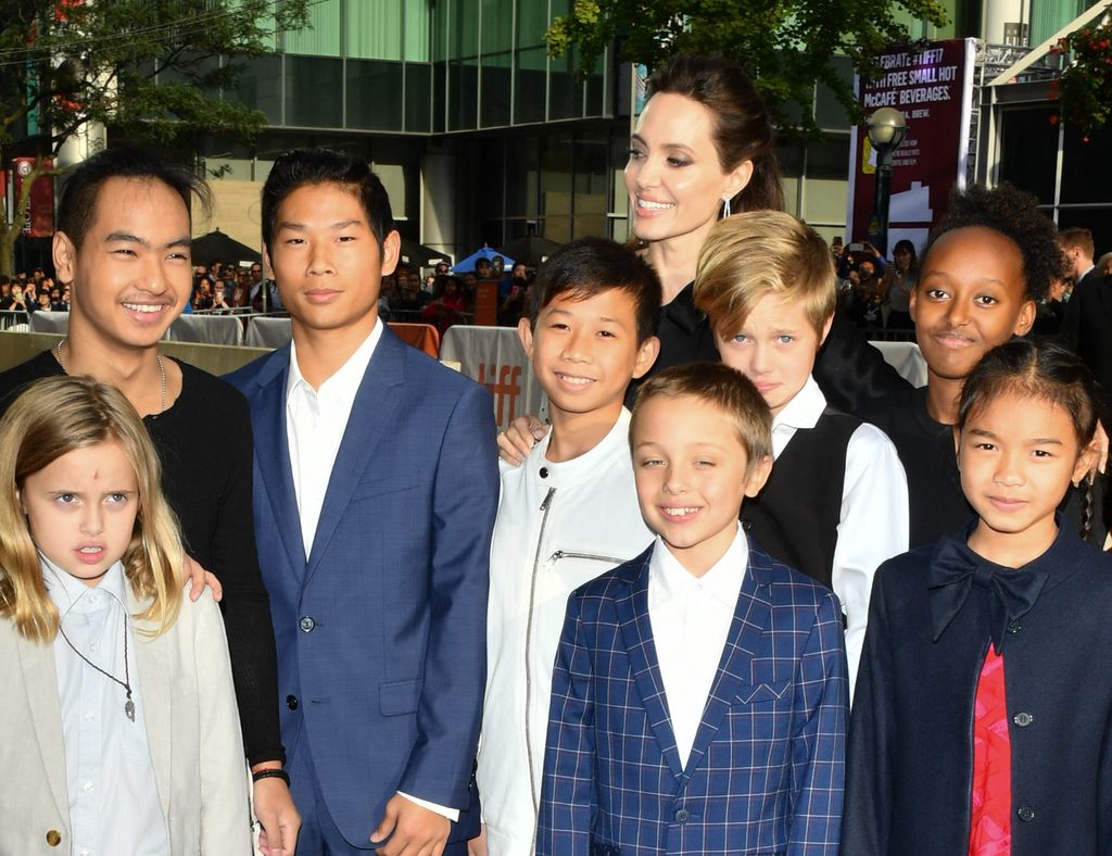 Angelina Jolie surrounded by her children and two child stars at a red carpet film premiere