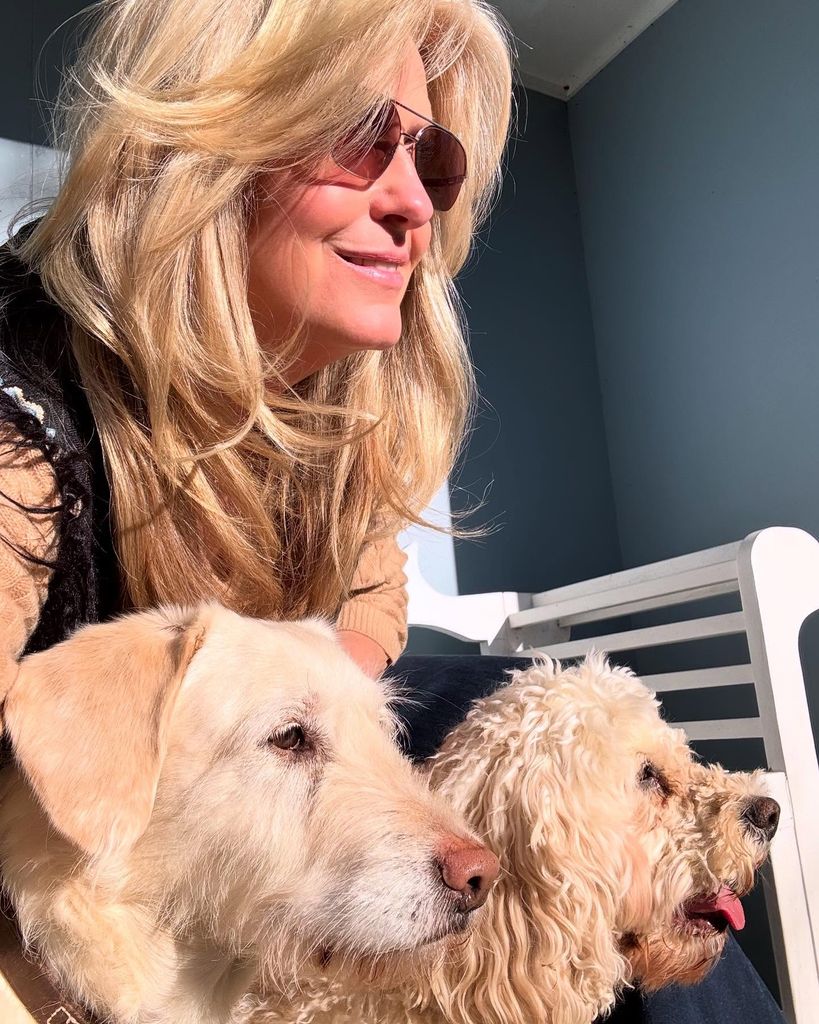 Penny Lancaster posing at home with dogs Bubbles and Lily 