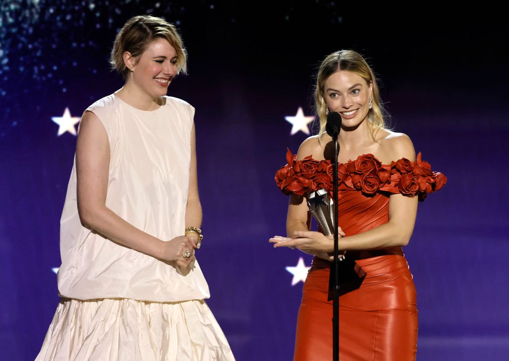 Greta Gerwig (with Margot Robbie) accepts the Best Director Award for 'Barbie' onstage during the 29th Annual Critics Choice Awards at Barker Hangar on January 14, 2024 in Santa Monica, California.