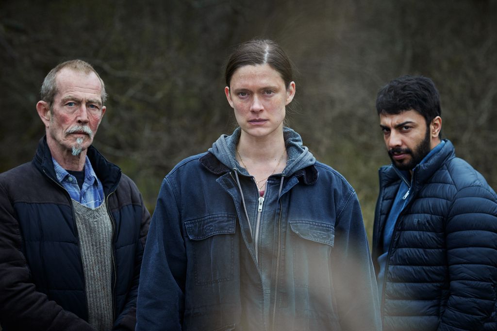 three people looking into camera