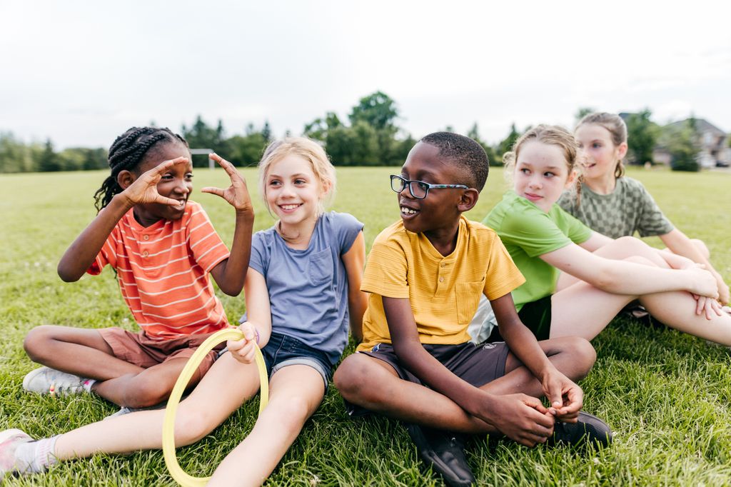 Kids Learning Through Play sitting in a semi circle