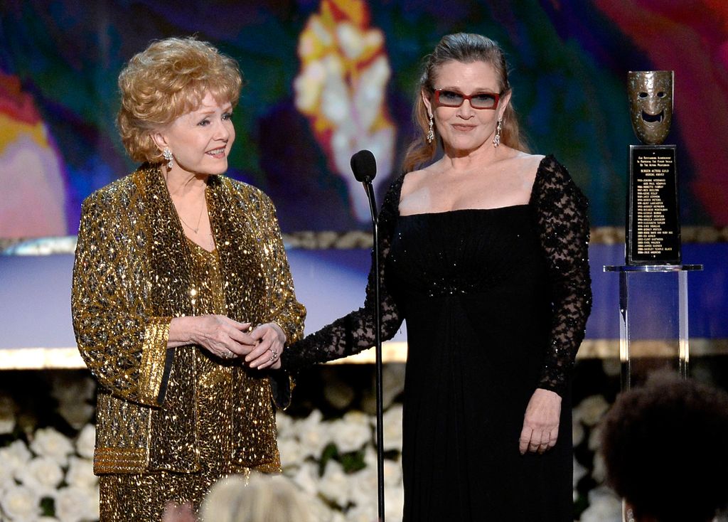 Actress Debbie Reynolds (L) accepts the Life Achievement Award from actress Carrie Fisher onstage at the 21st Annual Screen Actors Guild Awards at The Shrine Auditorium on January 25, 2015 in Los Angeles, California. 