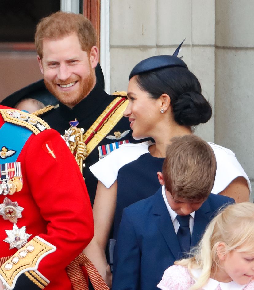 Harry and Meghan smiling on balcony in 2019