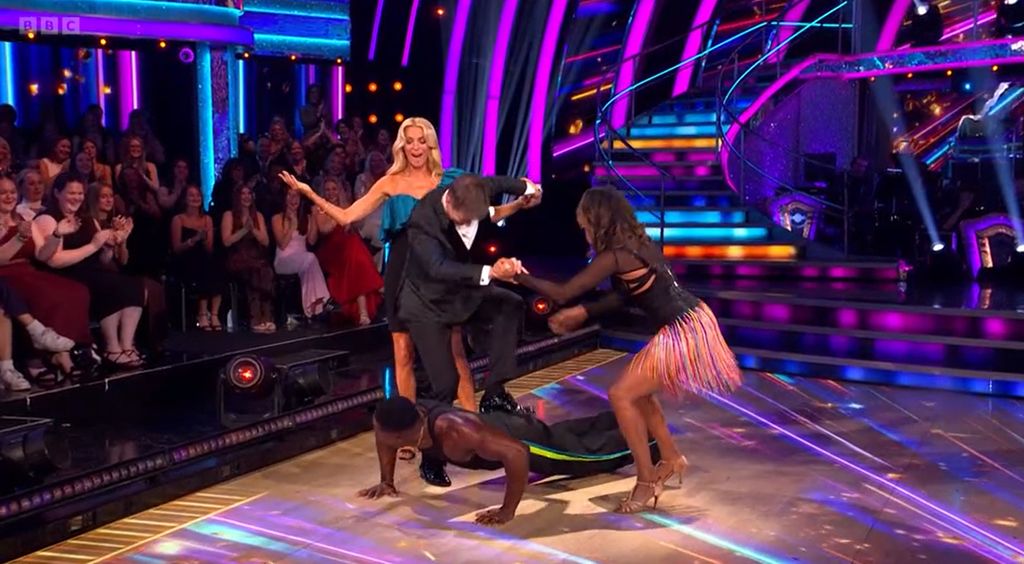 Anton Du Beke standing on Harry Aikines-Aryeetey's back with the star doing a push up